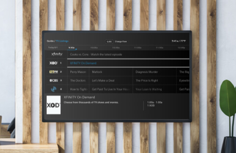XFINITY On Demand TV listings on a wall-mounted big screen TV